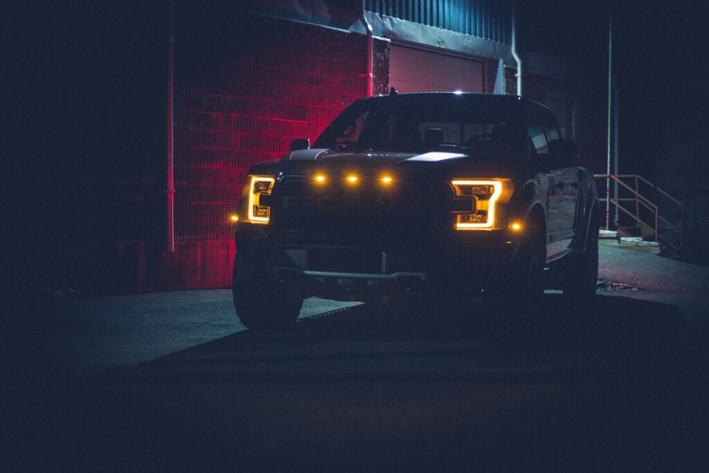 black car parked near red building