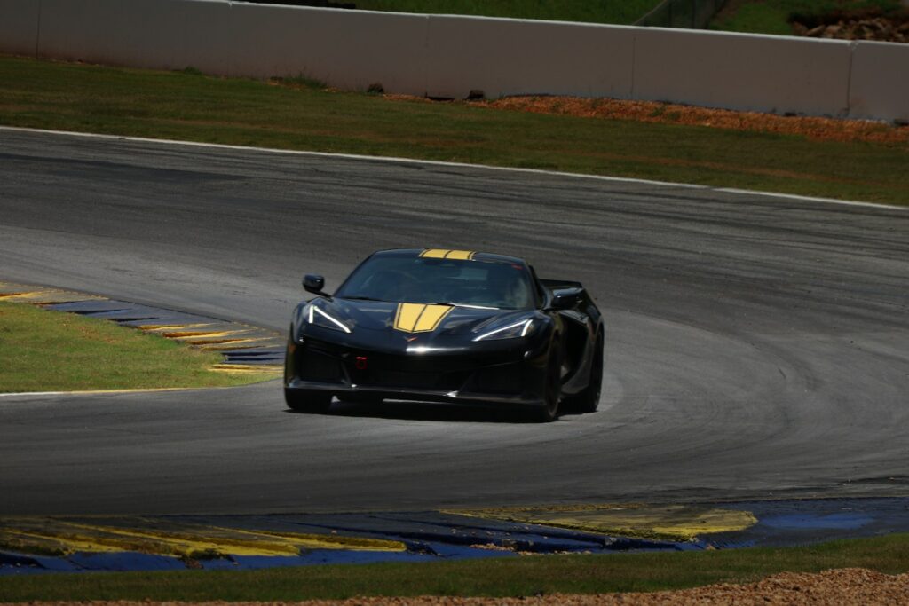 A sports car speeds around a race track.