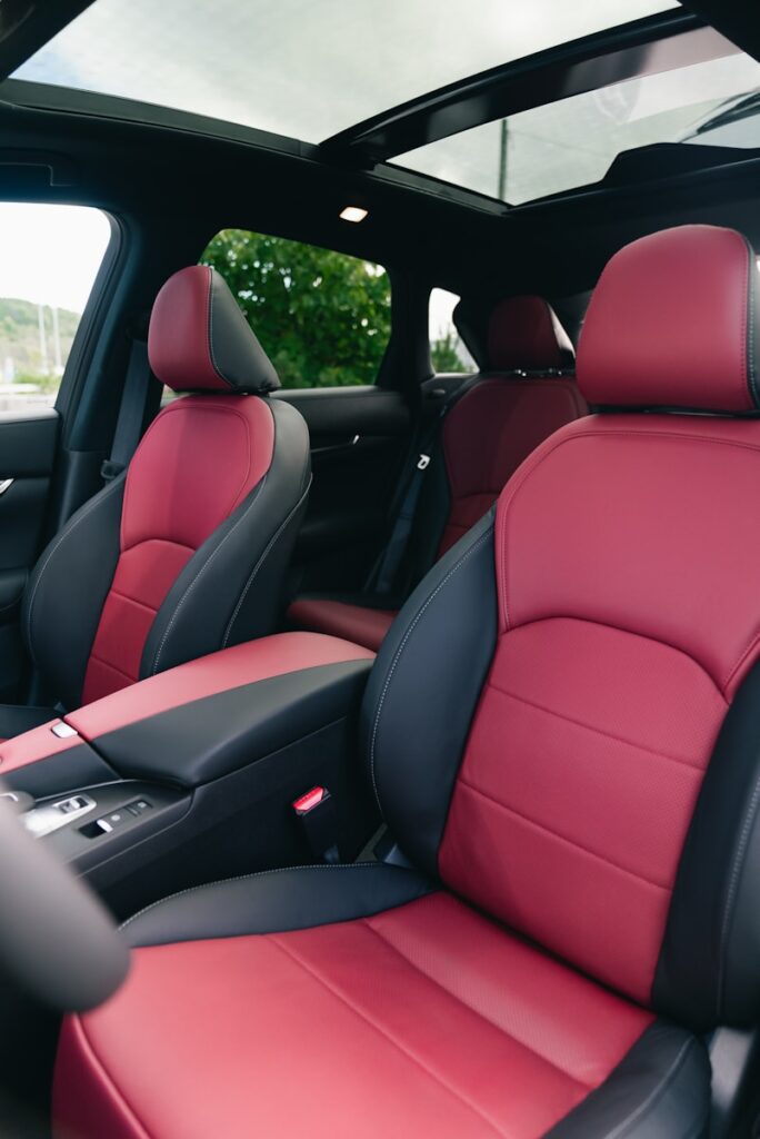 Red and black leather car interior with sunroof.