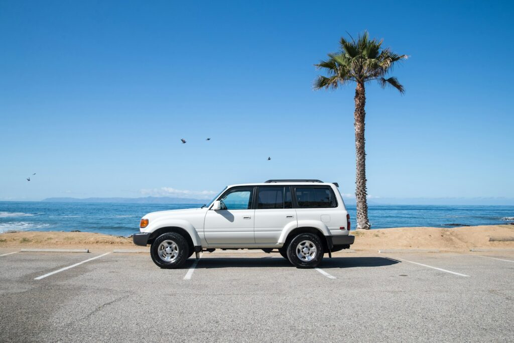 white suv on beach during daytime