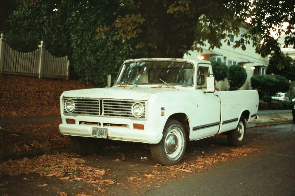 a white truck parked on the side of a road