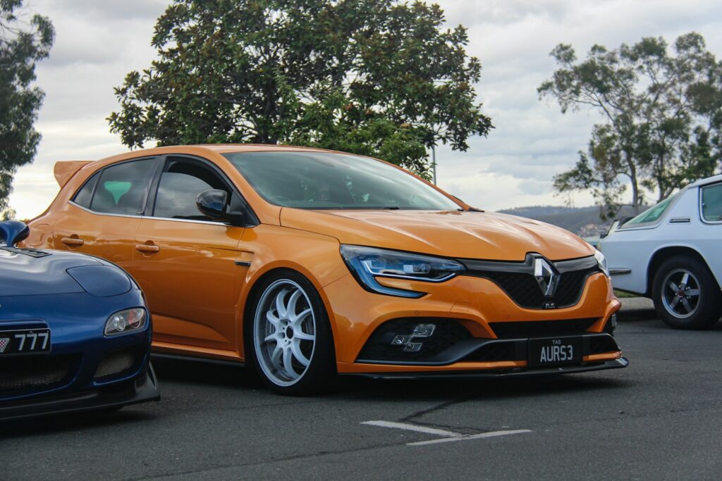 Orange renault sports car parked outdoors