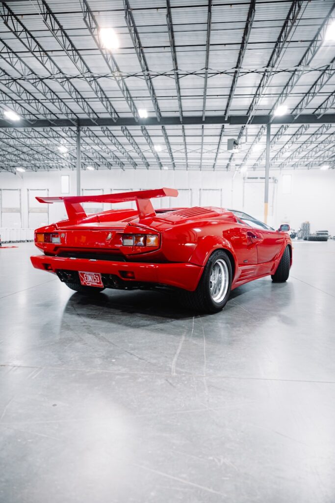 Red sports car with a large rear spoiler.