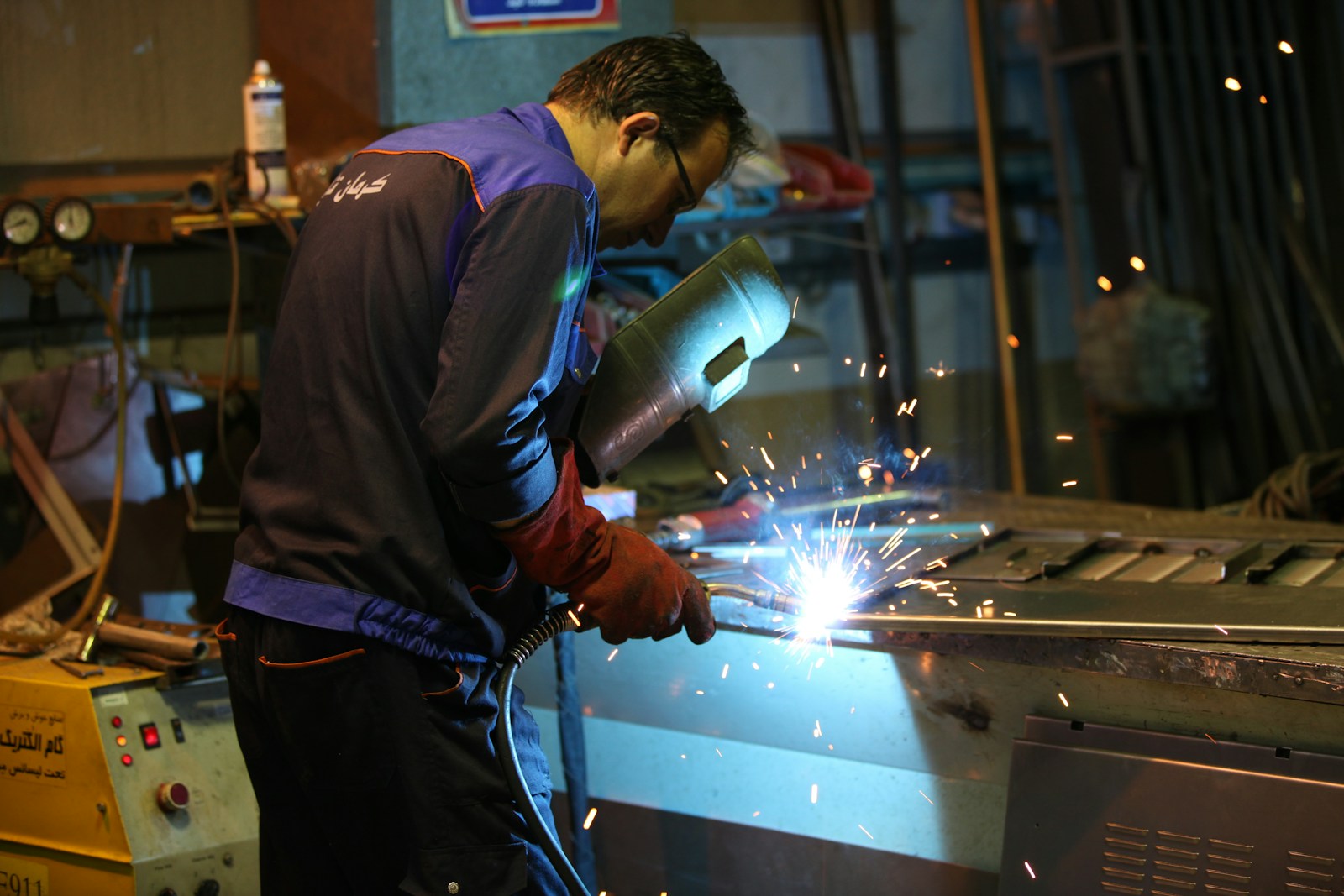 a man working with a grinder in a factory