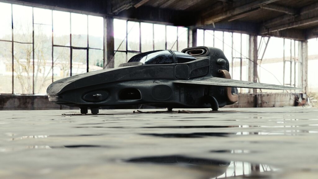 a black object sitting on top of a puddle of water