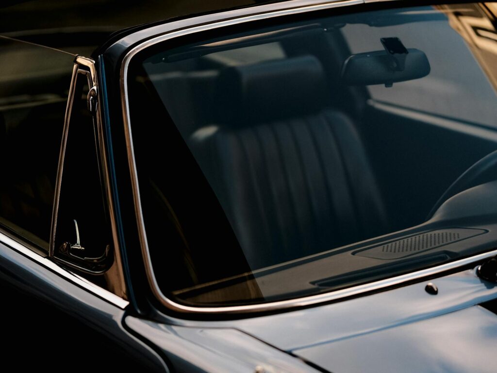Close-up shot of a vintage car's windshield capturing a nostalgic and classic automotive style.