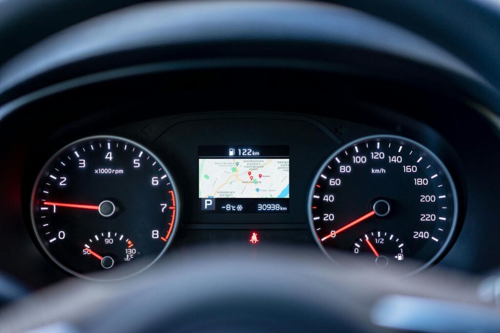 Close-up of a car dashboard showing speedometer, tachometer, and GPS display.