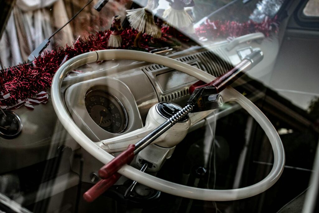 Close-up of a classic car's steering wheel with an anti-theft lock.