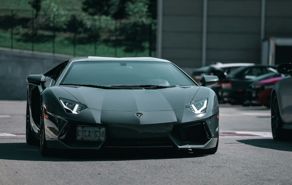 A sleek Lamborghini Aventador sports car is showcased in an outdoor setting, epitomizing modern luxury.