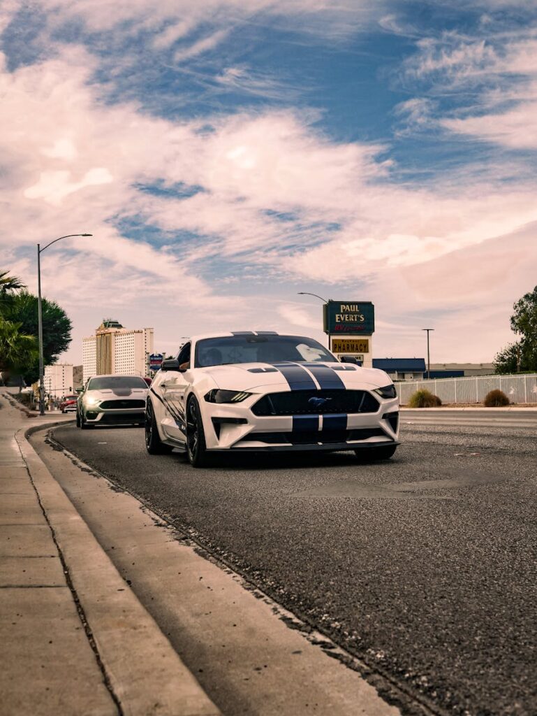 Dynamic view of sports cars on an urban road, capturing the essence of speed and style.
