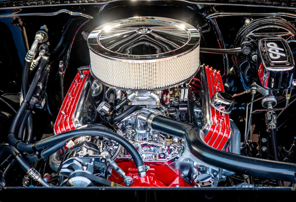 Close-up of a polished and high-performance car engine with visible components and pipes.