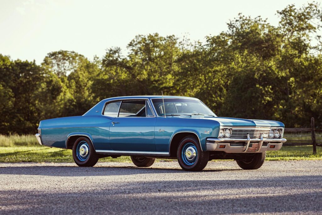 A beautifully restored 1966 Chevrolet Caprice showcased in a scenic outdoors setting, highlighting its vintage charm.