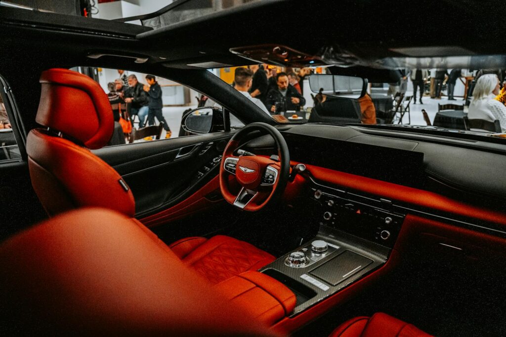 Explore the luxury of a high-end car interior with vibrant red leather seats and advanced controls.