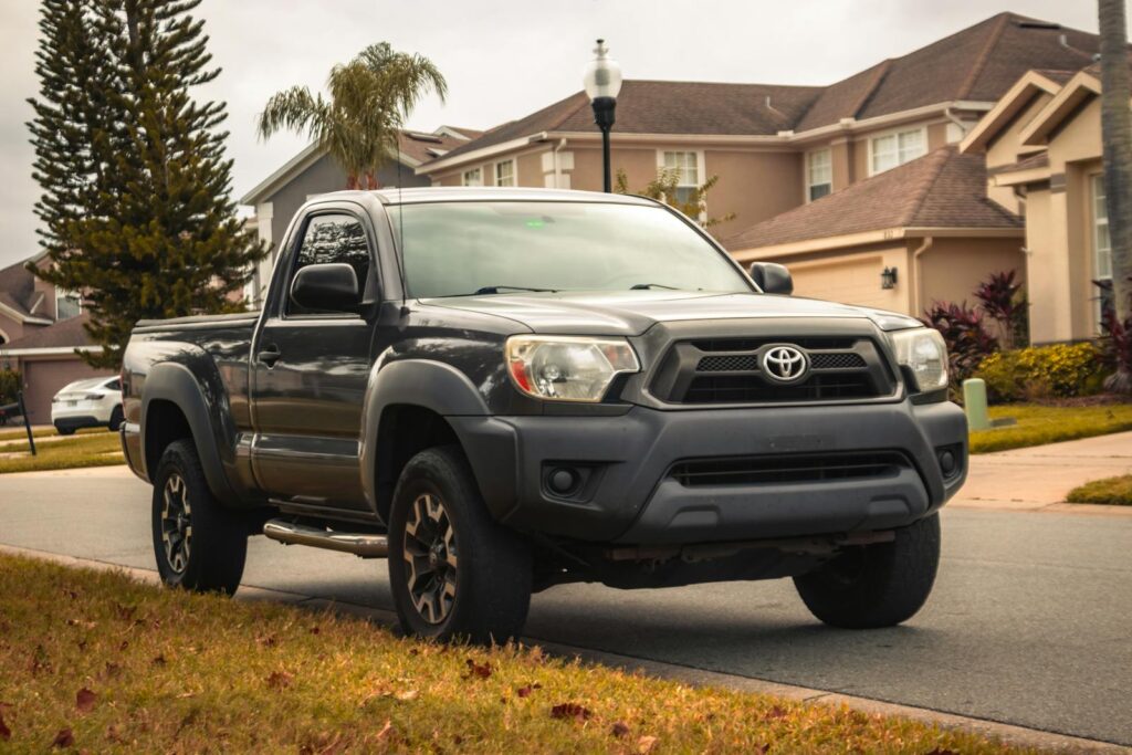Gray Toyota Tacoma parked in a suburban neighborhood street of Winter Springs, FL.
