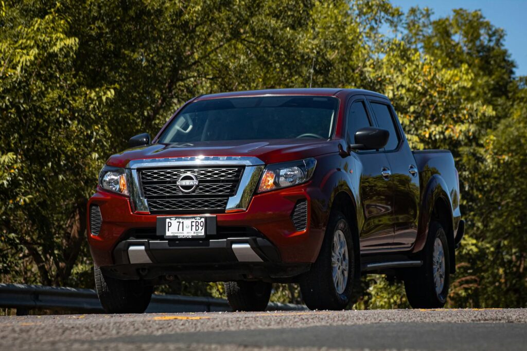 Powerful red pickup truck captured outdoors on a scenic road.
