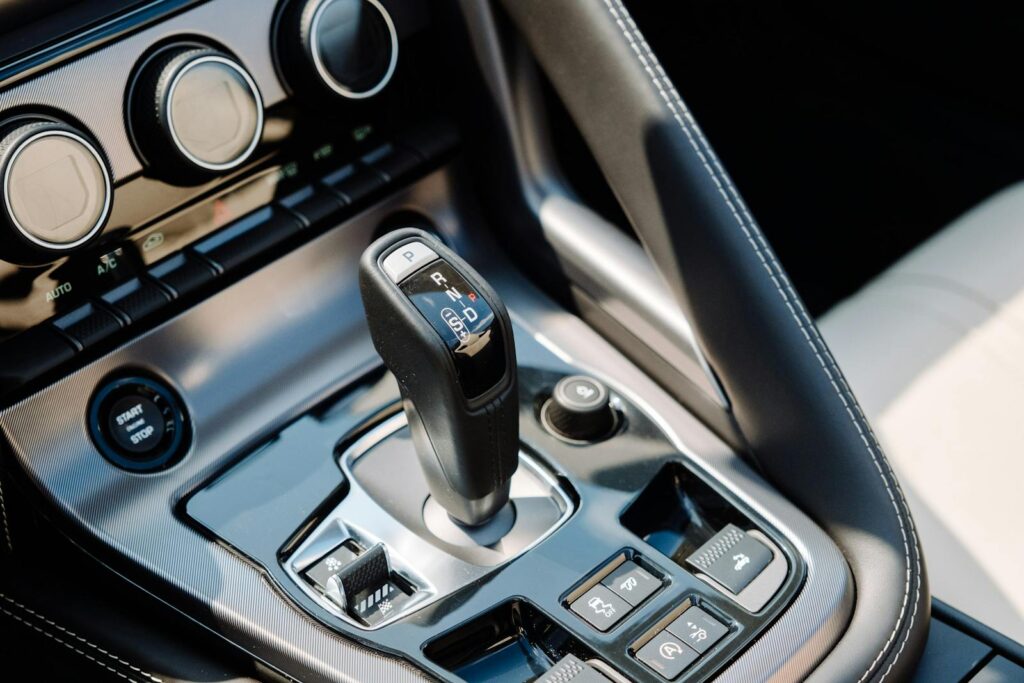 Detailed shot of a luxury sports car's gear shifter and control panel.