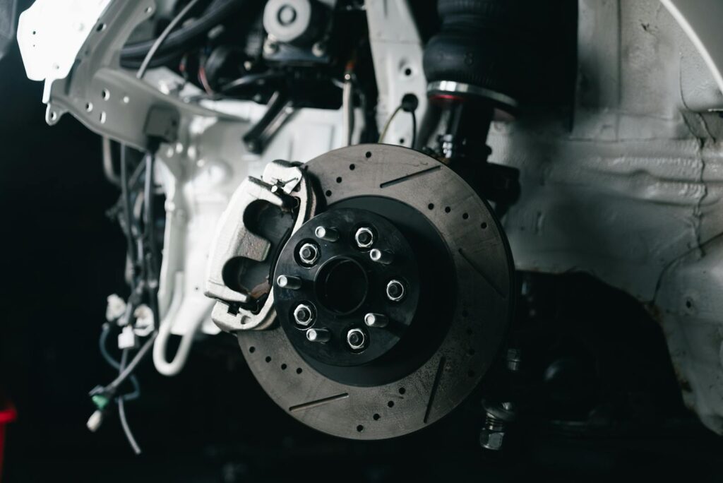 Detailed view of a vehicle's disc brake system with caliper, showcasing automotive technology.