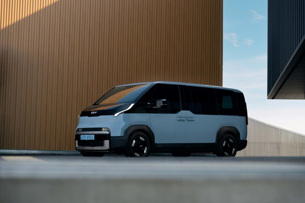 Modern electric vehicle parked outdoors showcasing sleek design and contemporary architecture.