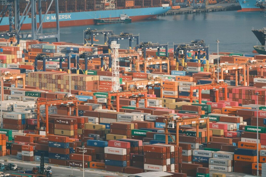 Busy shipping port with many stacked cargo containers