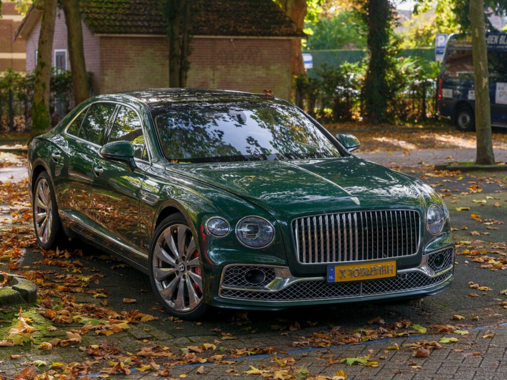 A green car parked on the side of the road
