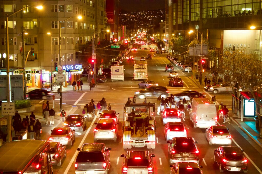Busy city street at night with traffic congestion.