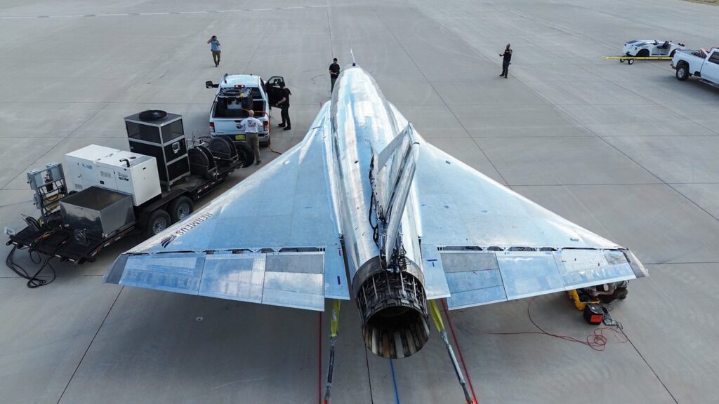 A delta-wing jet aircraft on an airfield