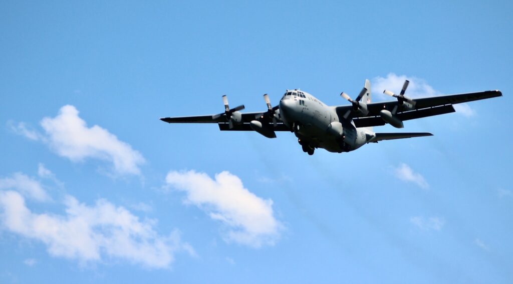 black jet plane in mid air during daytime