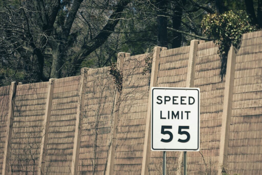 white and black speed limit 55 sign
