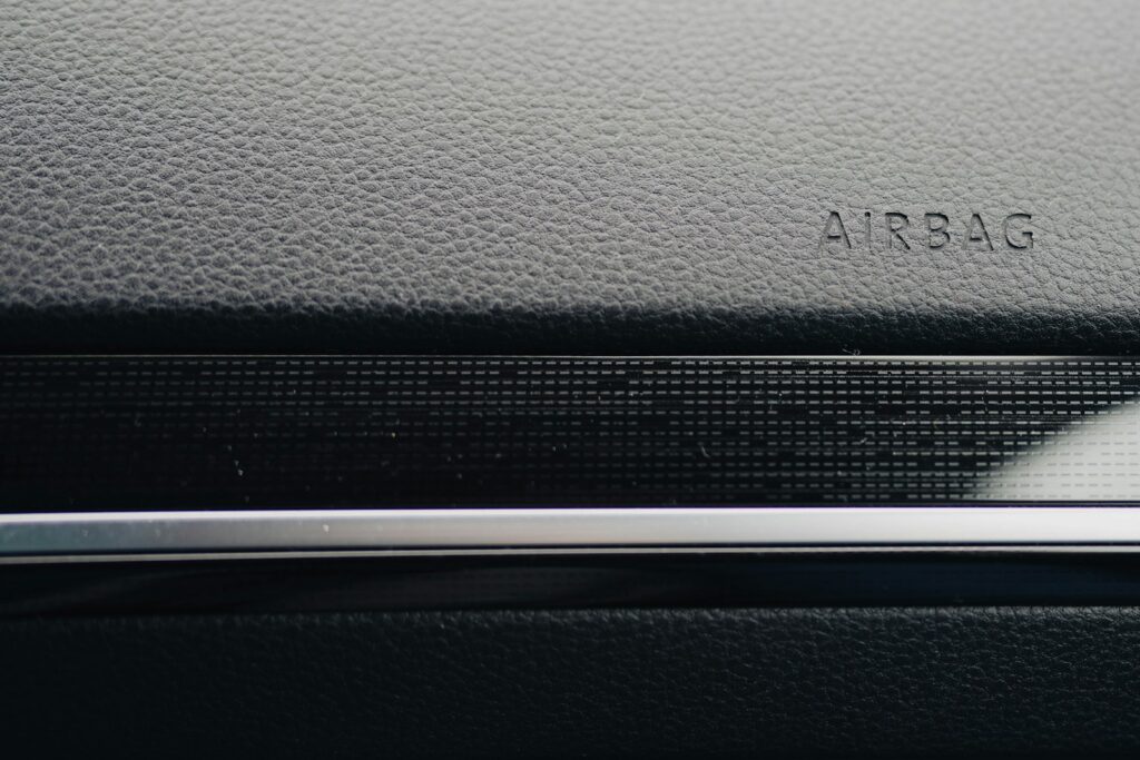 Close-up of a car's dashboard, showing "airbag."