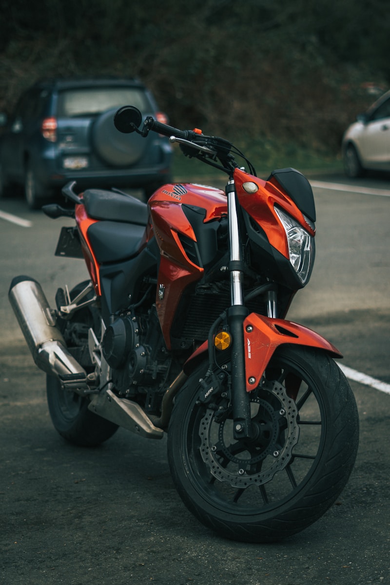 a red motorcycle parked on the side of the road
