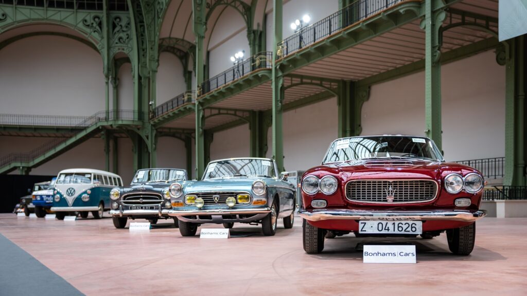 A row of old cars parked in a building