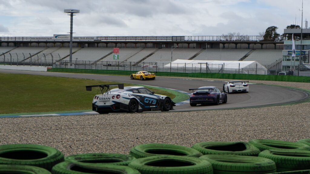 a group of cars driving around a track