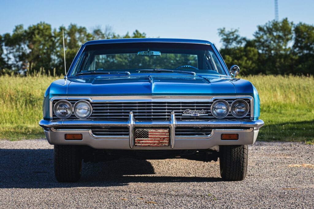 A blue car parked in a parking lot