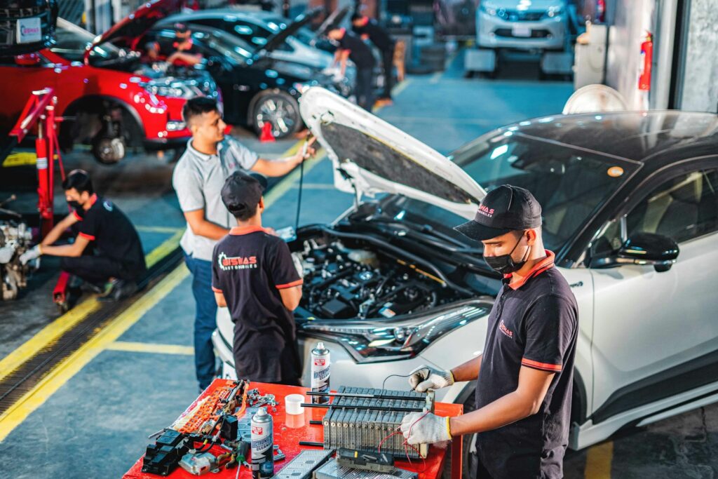 A group of men working on a car in a garage
