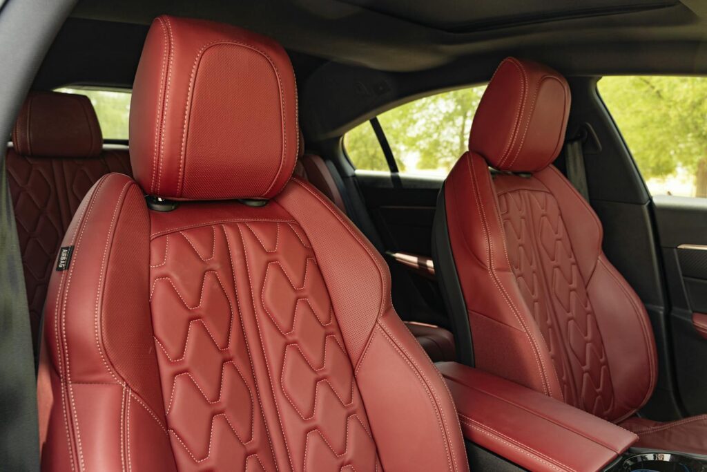 Luxurious red leather car seats inside a modern vehicle, capturing opulence and comfort.