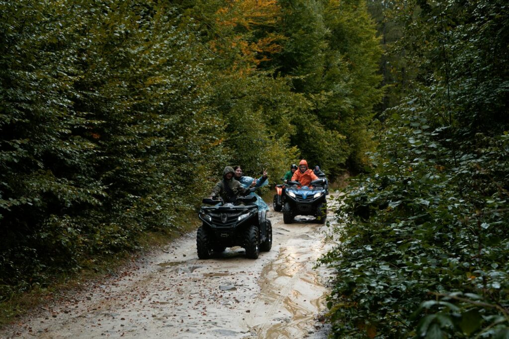 Group enjoying an adventurous ATV ride through a lush forest trail, exploring nature.
