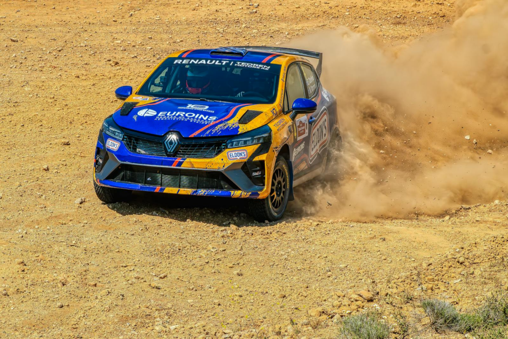 A Renault Clio rally car kicks up dust during a thrilling off-road rally race in Thebes, Greece.