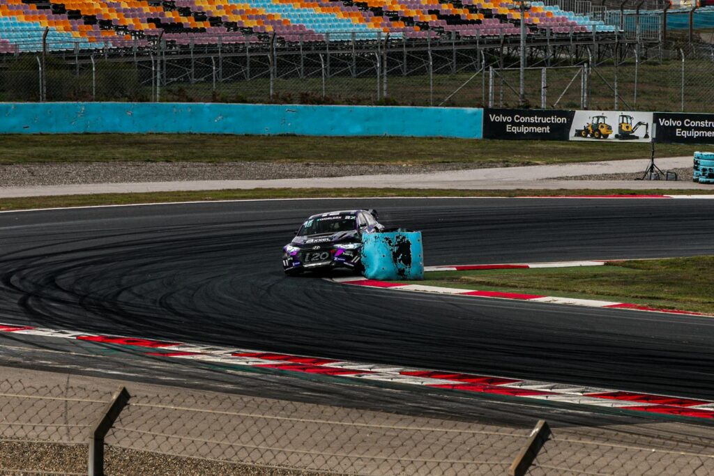 A thrilling rally race car navigates a sharp curve on a speed track, capturing the intensity of motorsport racing.