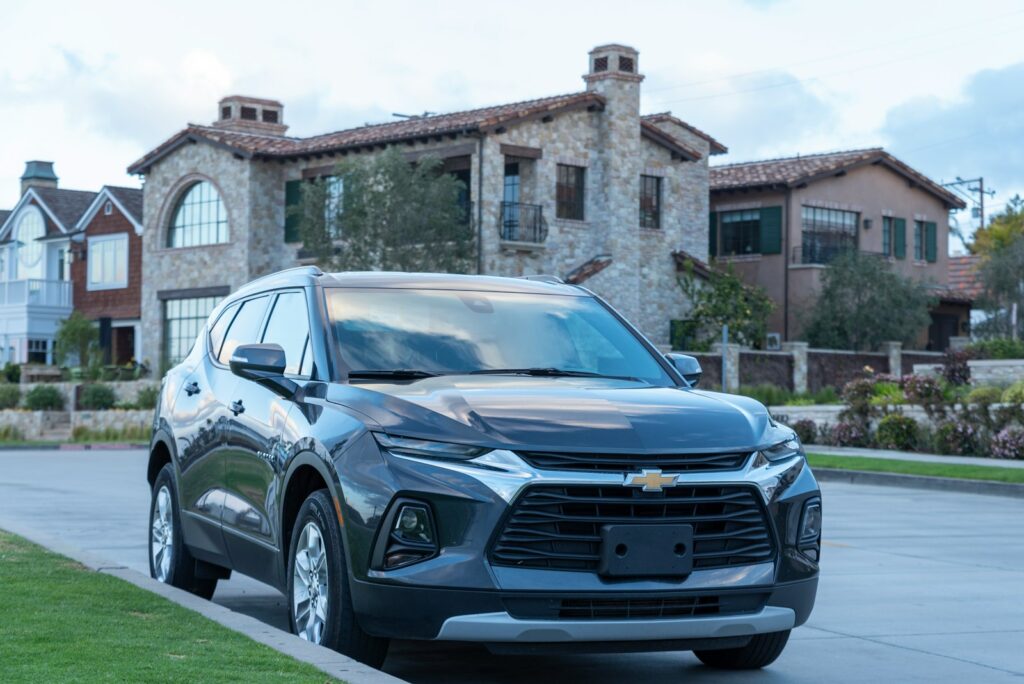 a silver chevrolet suv parked in front of a house