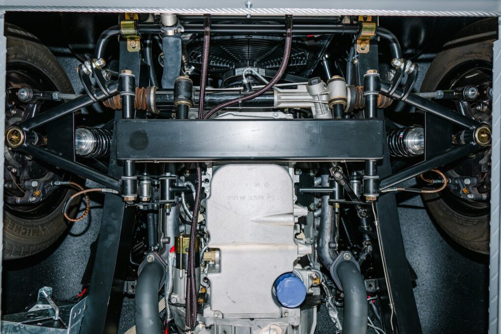 Underside view of a complex car engine and suspension.