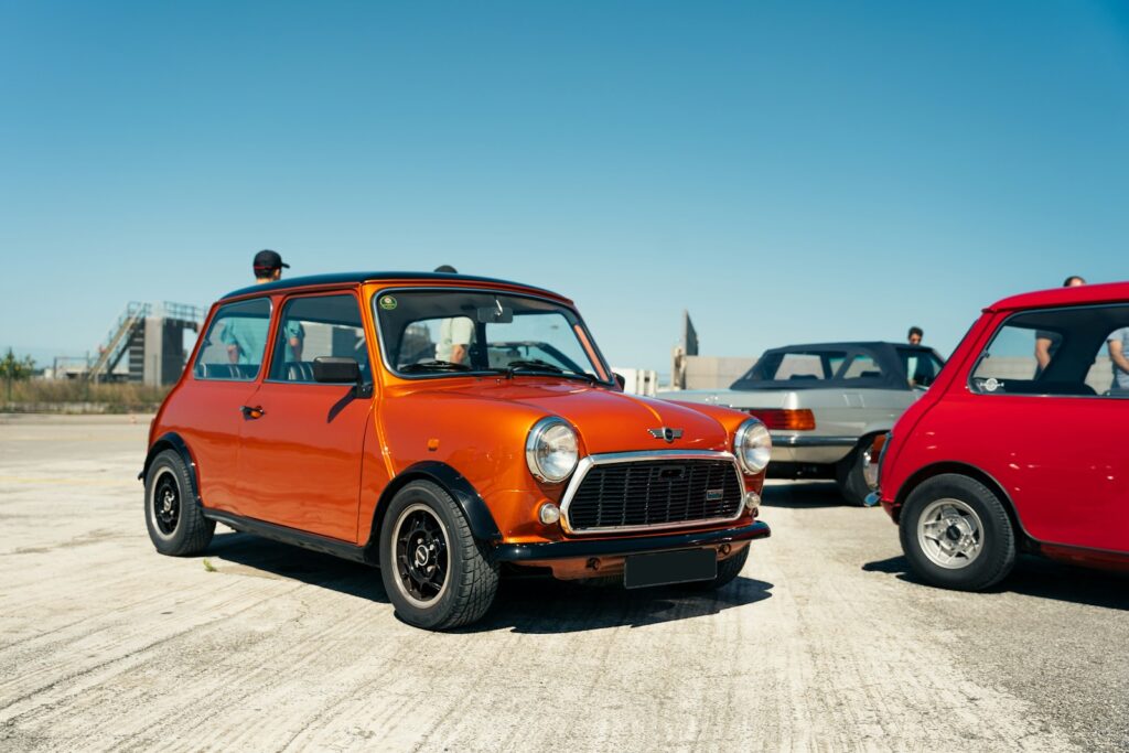 A couple of small cars parked next to each other