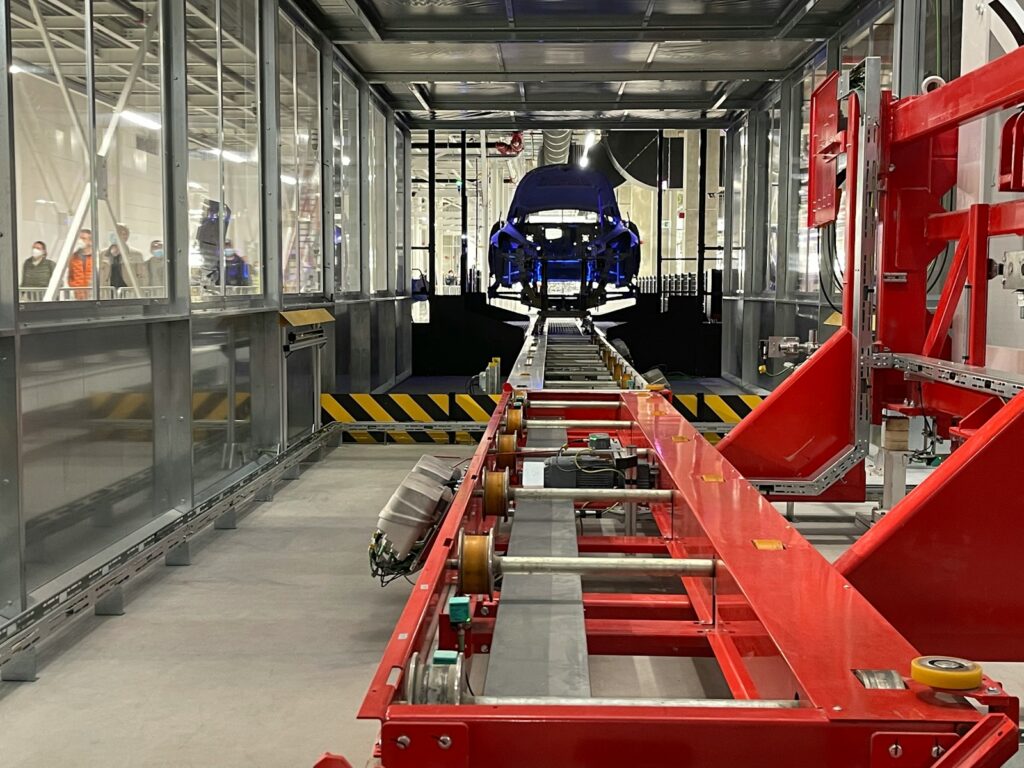 a car being built in a large factory