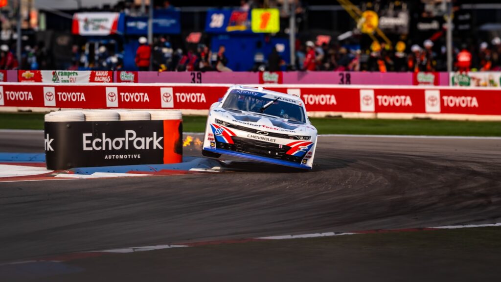 Race car skids around a corner on track