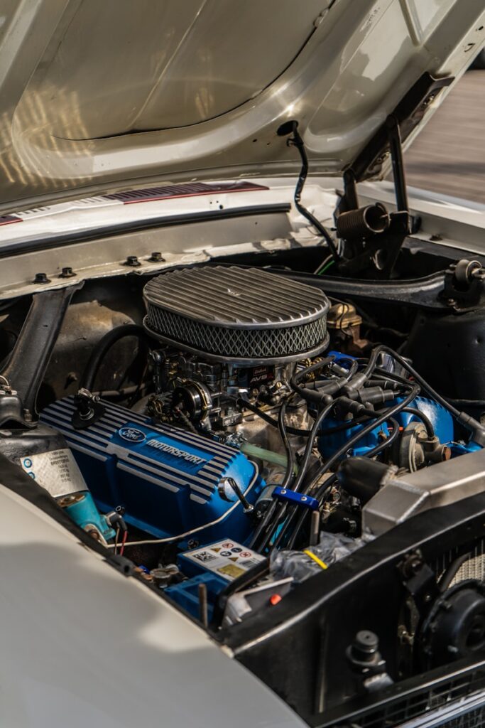 Close-up of a vintage car engine with blue valve covers