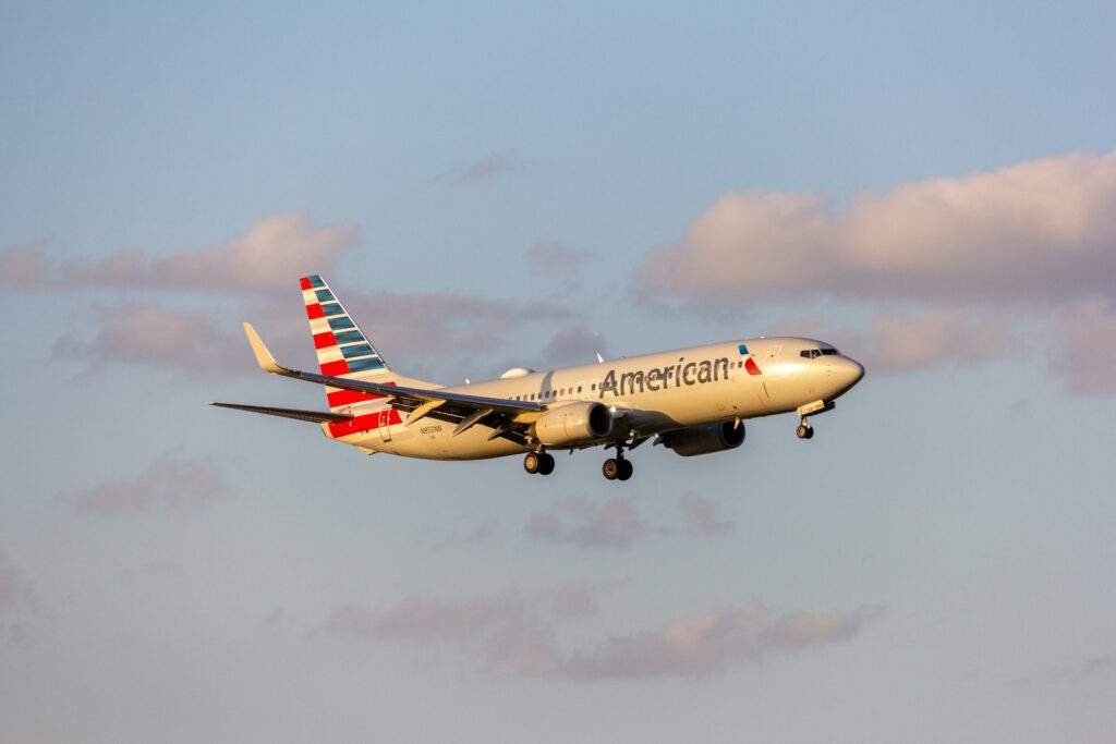 A large passenger jet flying through a blue sky