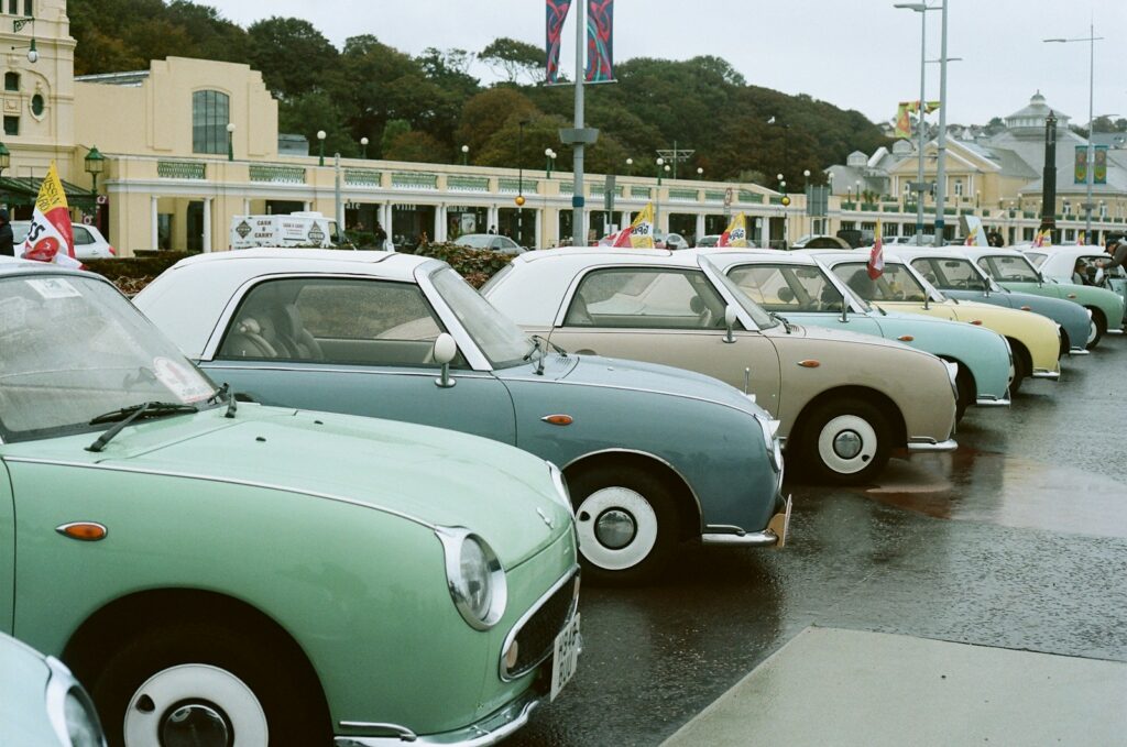 Row of vintage pastel cars parked outdoors