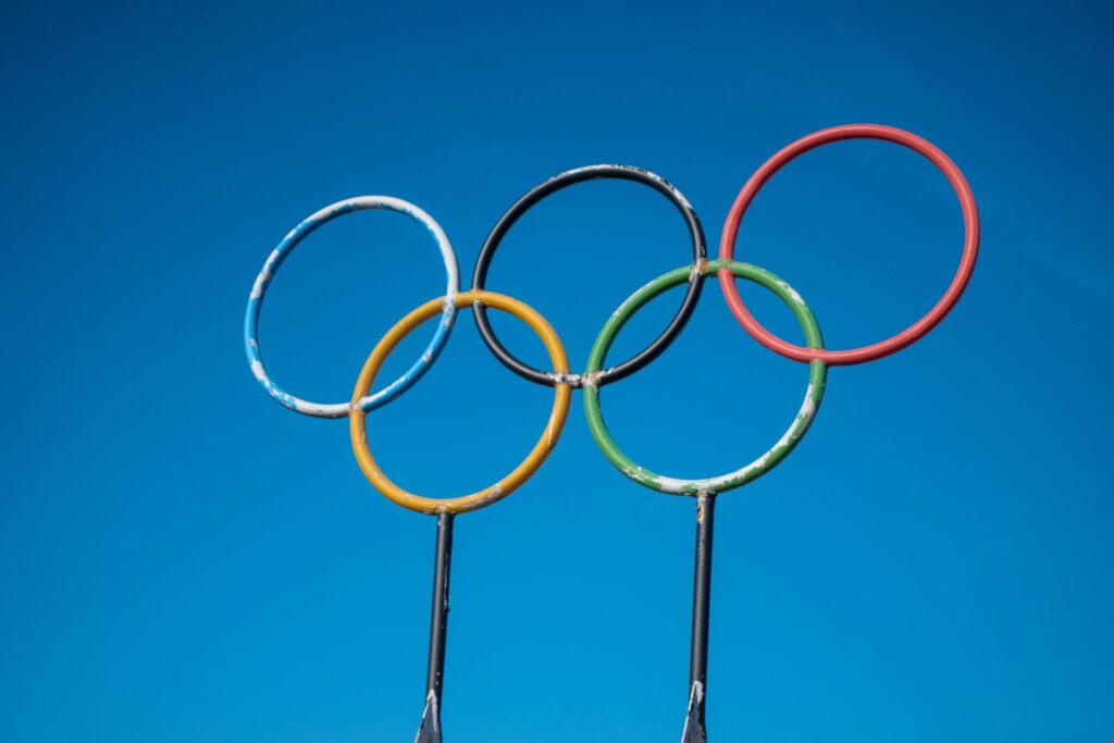 Olympic rings sculpture set against a clear blue sky in Lahti, Finland.
