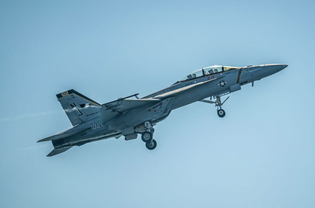 The Boeing F/A-18 Super Hornet depicted in a clear blue sky, showcasing military aviation prowess.