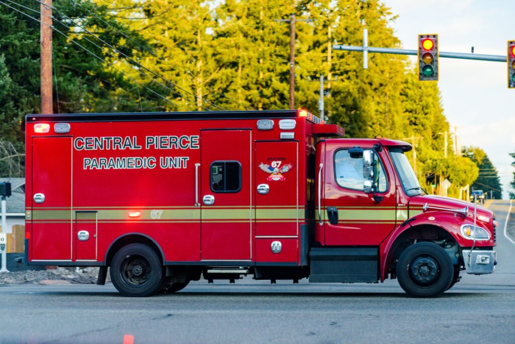 Red paramedic truck from Central Pierce seen at an intersection, providing emergency services.