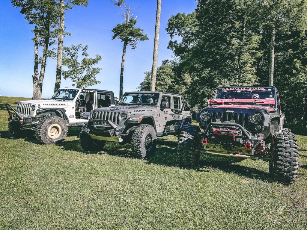 a group of vehicles parked in a grassy field